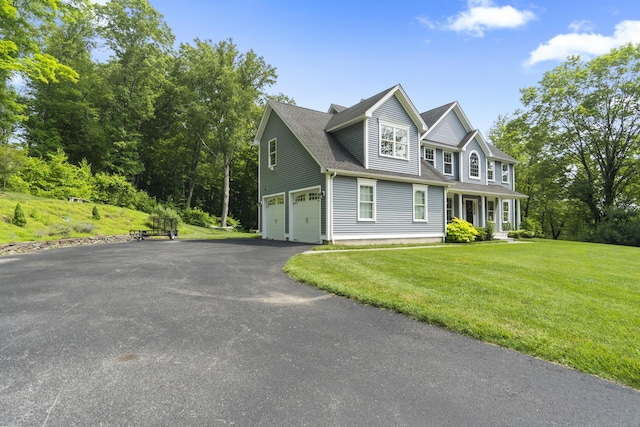 257 Ichabod Rd, Southbury, CT 06488 - view of front of home featuring a garage, asphalt driveway, a front yard, and roof with shingles