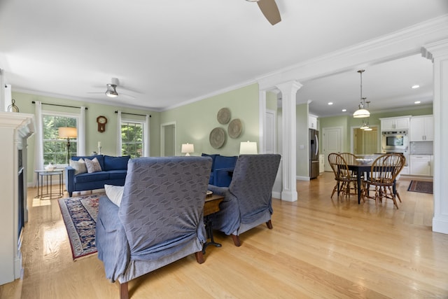 257 Ichabod Rd, Southbury, CT 06488 - living room with a ceiling fan, decorative columns, light wood finished floors, crown molding, and a fireplace