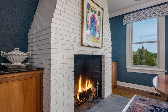 77 E Wharf Rd, Madison, CT 06443 - detailed view of a fireplace, wood finished floors, and crown molding