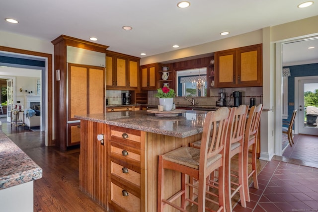 77 E Wharf Rd, Madison, CT 06443 - kitchen featuring brown cabinetry, a kitchen island, tasteful backsplash, open shelves, and recessed lighting