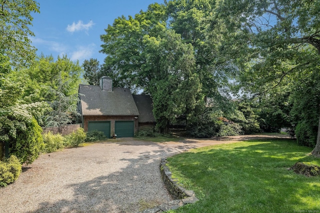 77 E Wharf Rd, Madison, CT 06443 - view of side of property with driveway, a chimney, and a garage