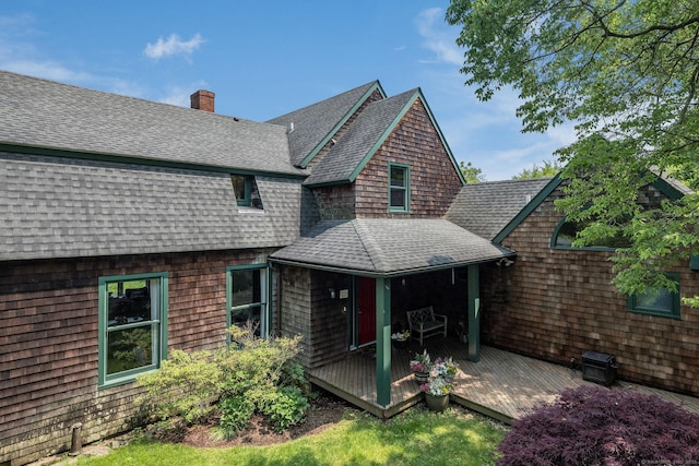 77 E Wharf Rd, Madison, CT 06443 - back of property featuring roof with shingles, a chimney, and a deck