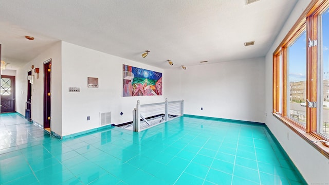 167 George St, Hartford, CT 06114 - tiled spare room with plenty of natural light and a textured ceiling