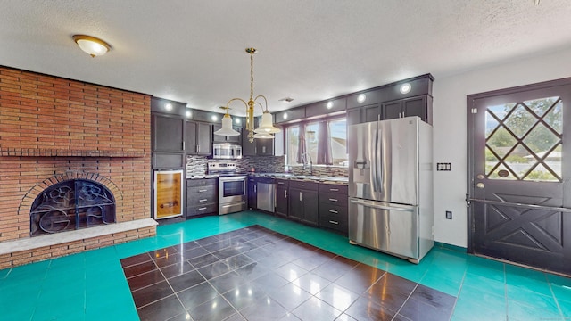 167 George St, Hartford, CT 06114 - kitchen with appliances with stainless steel finishes, healthy amount of natural light, dark tile patterned flooring, a textured ceiling, and tasteful backsplash