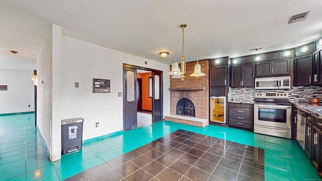 167 George St, Hartford, CT 06114 - kitchen with stainless steel appliances, tile patterned floors, a fireplace, tasteful backsplash, and dark countertops