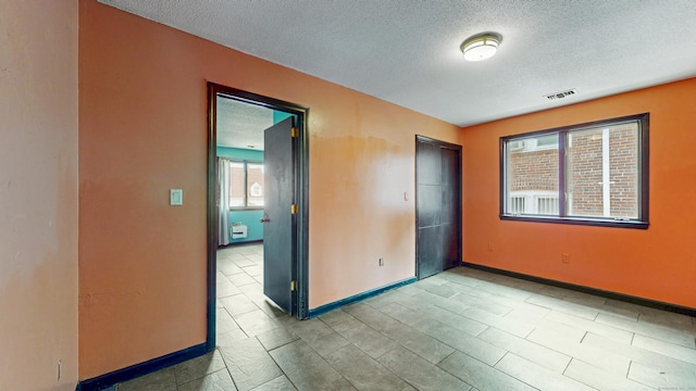 167 George St, Hartford, CT 06114 - unfurnished room featuring a textured ceiling and baseboards