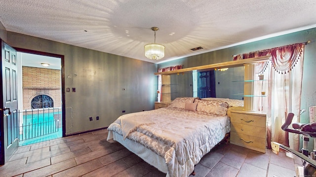 167 George St, Hartford, CT 06114 - bedroom with a textured ceiling, a chandelier, and access to outside