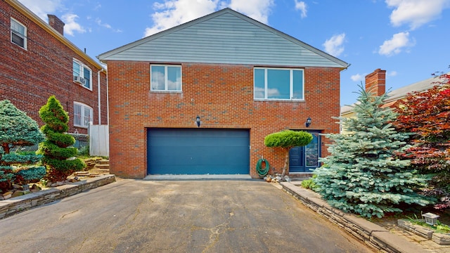 167 George St, Hartford, CT 06114 - view of front of house with driveway, a garage, and brick siding