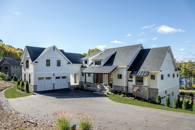 103 Chalybes Rd W, Roxbury, CT 06783 - modern farmhouse style home with stone siding, board and batten siding, asphalt driveway, a garage, and covered porch