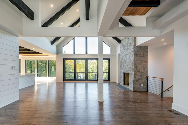103 Chalybes Rd W, Roxbury, CT 06783 - unfurnished living room with beamed ceiling, healthy amount of natural light, high vaulted ceiling, a fireplace, and wood finished floors