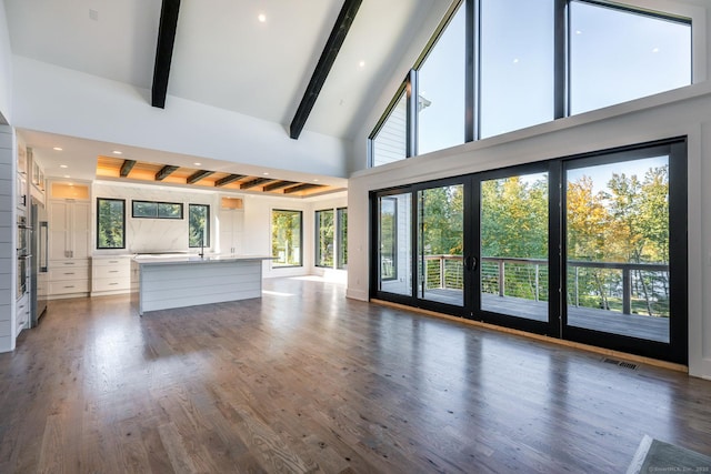 103 Chalybes Rd W, Roxbury, CT 06783 - unfurnished living room with beamed ceiling, high vaulted ceiling, recessed lighting, and wood finished floors
