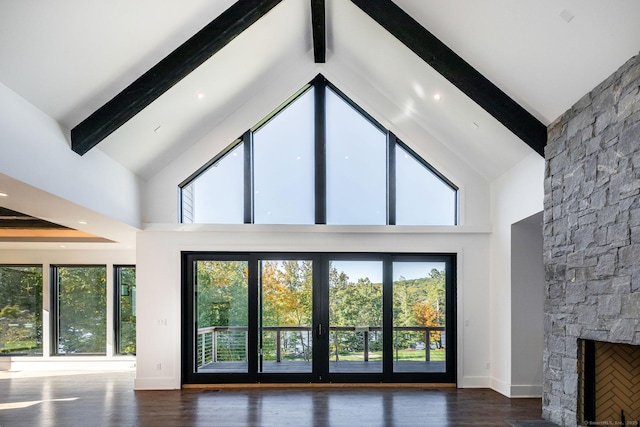 103 Chalybes Rd W, Roxbury, CT 06783 - unfurnished living room with beamed ceiling, a stone fireplace, high vaulted ceiling, and wood finished floors