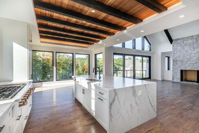 103 Chalybes Rd W, Roxbury, CT 06783 - kitchen featuring open floor plan, stainless steel gas stovetop, plenty of natural light, light stone counters, and a wood ceiling with exposed beams