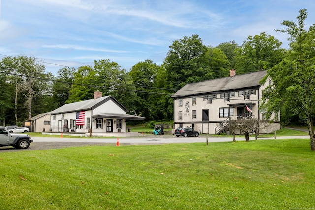 103 Chalybes Rd W, Roxbury, CT 06783 - view of front of house with a chimney, a front yard, and view of wooded area
