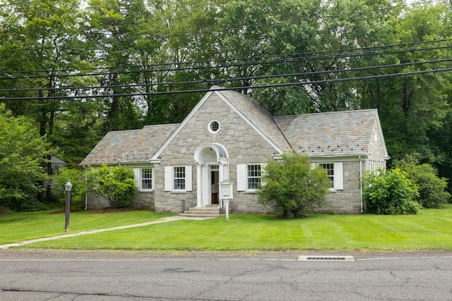 103 Chalybes Rd W, Roxbury, CT 06783 - view of front of home featuring stone siding, a high end roof, a front lawn, and view of scattered trees