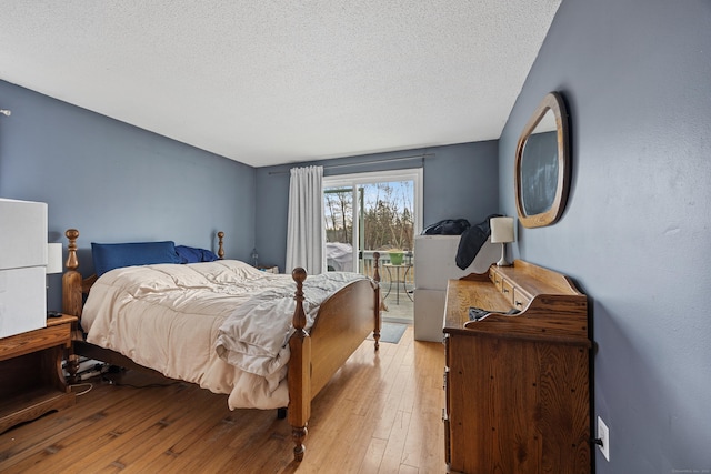 52 Irving St Apt 4, Bristol, CT 06010 - bedroom featuring access to outside, a textured ceiling, and light wood finished floors