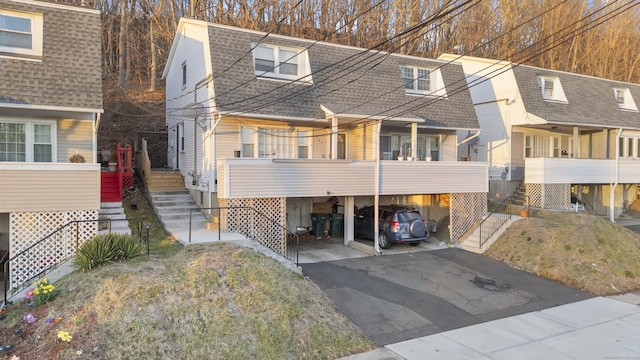 305 Mill Rock Rd Unit 305, Hamden, CT 06517 - view of front facade with a shingled roof, driveway, and stairway