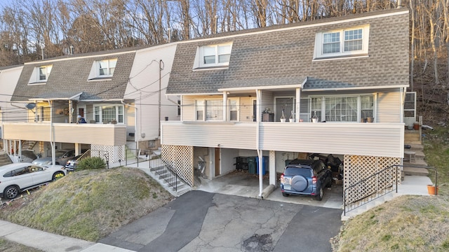 305 Mill Rock Rd Unit 305, Hamden, CT 06517 - view of front of house featuring a shingled roof, stairway, a carport, and asphalt driveway