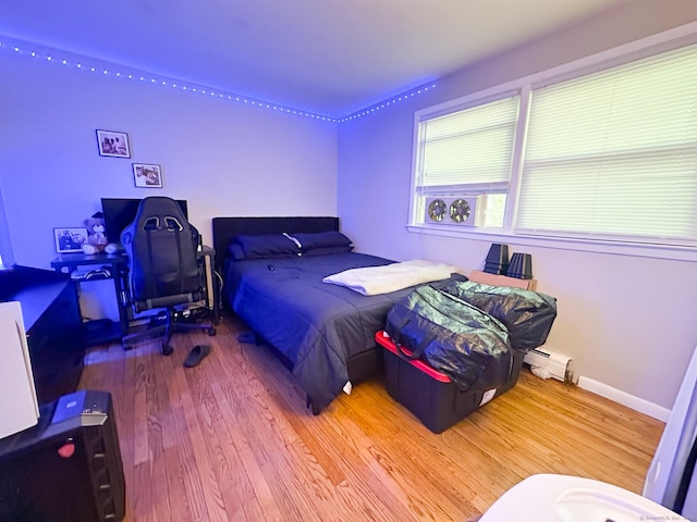 305 Mill Rock Rd Unit 305, Hamden, CT 06517 - bedroom with wood finished floors and a baseboard heating unit
