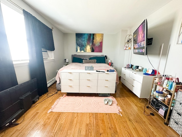 305 Mill Rock Rd Unit 305, Hamden, CT 06517 - bedroom featuring a baseboard heating unit and wood finished floors