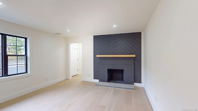 101 Parade Hill Rd, New Canaan, CT 06840 - unfurnished living room with light wood-style floors, recessed lighting, and a fireplace