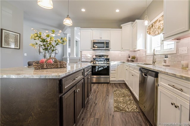 2 Lombard Cir Unit 2, North Haven, CT 06473 - kitchen with stainless steel appliances, dark wood-type flooring, white cabinetry, backsplash, and decorative light fixtures
