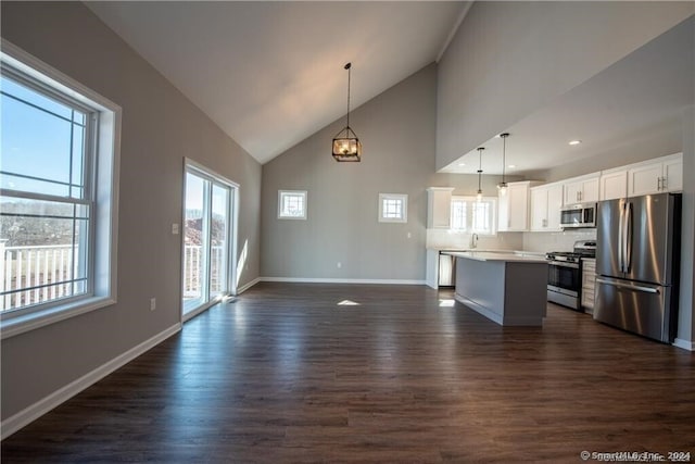 4 Lombard Cir Unit 4, North Haven, CT 06473 - kitchen featuring stainless steel appliances, open floor plan, dark wood-style flooring, white cabinets, and high vaulted ceiling