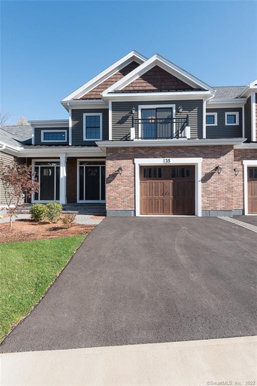 120 Yorkshire Ct Unit 120, Farmington, CT 06032 - view of front of house with a garage, driveway, brick siding, and a balcony
