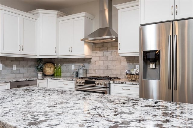 120 Yorkshire Ct Unit 120, Farmington, CT 06032 - kitchen featuring stainless steel appliances, wall chimney range hood, white cabinetry, light stone counters, and decorative backsplash