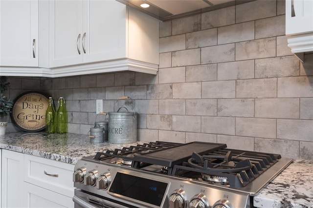 120 Yorkshire Ct Unit 120, Farmington, CT 06032 - kitchen with stainless steel range with gas cooktop, white cabinetry, backsplash, and light stone countertops
