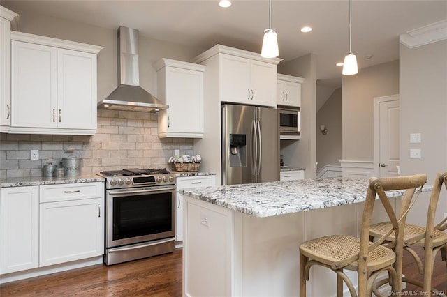120 Yorkshire Ct Unit 120, Farmington, CT 06032 - kitchen featuring stainless steel appliances, wall chimney exhaust hood, a breakfast bar area, decorative backsplash, and white cabinetry