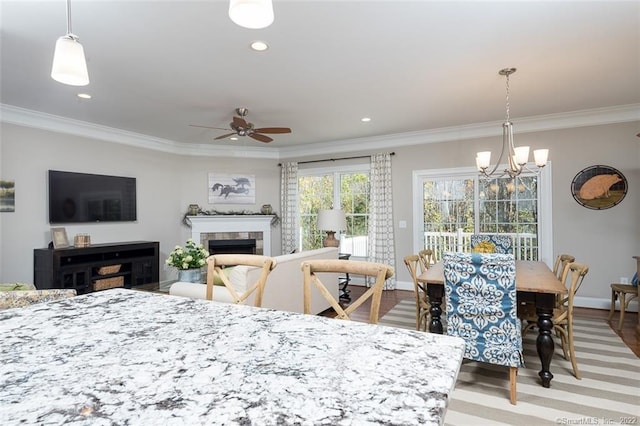 120 Yorkshire Ct Unit 120, Farmington, CT 06032 - dining area with crown molding, a ceiling fan, a tiled fireplace, a chandelier, and recessed lighting