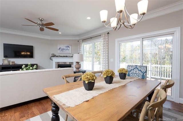 120 Yorkshire Ct Unit 120, Farmington, CT 06032 - dining space featuring dark wood-style flooring, a chandelier, crown molding, a tiled fireplace, and recessed lighting