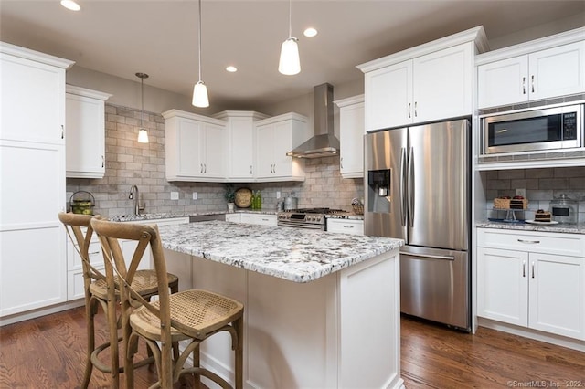 120 Yorkshire Ct Unit 120, Farmington, CT 06032 - kitchen featuring wall chimney range hood, appliances with stainless steel finishes, decorative backsplash, dark wood-style flooring, and recessed lighting