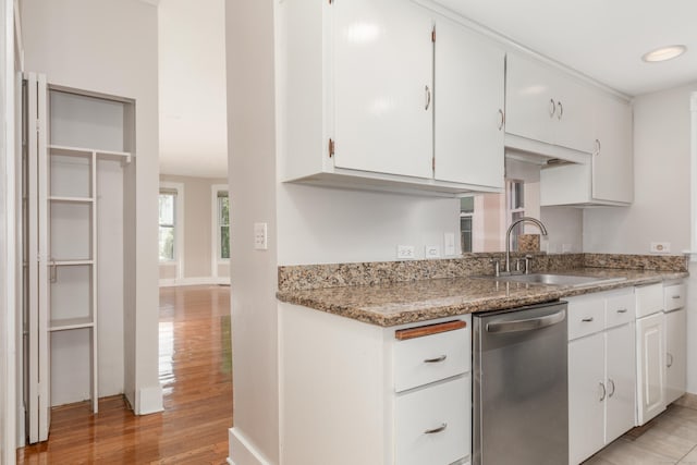 48 Livingston St, New Haven, CT 06511 - kitchen with stainless steel dishwasher, light wood-style floors, white cabinets, and light stone countertops