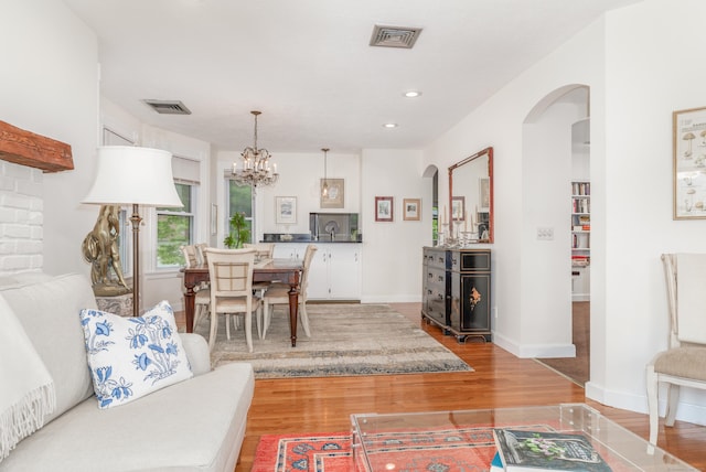 48 Livingston St, New Haven, CT 06511 - living area with arched walkways, wood finished floors, a chandelier, and recessed lighting