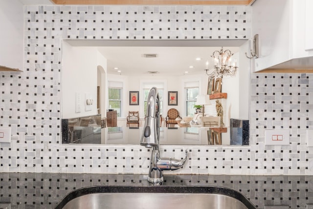 48 Livingston St, New Haven, CT 06511 - kitchen view of decorative backsplash, a chandelier, white cabinets, and arched walkways