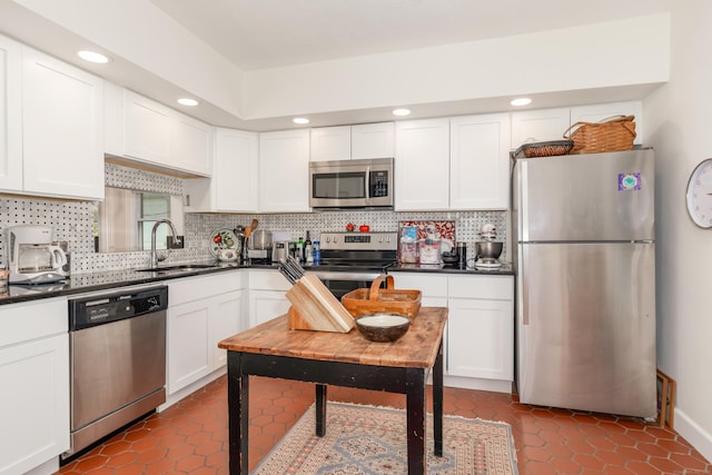 48 Livingston St, New Haven, CT 06511 - kitchen with appliances with stainless steel finishes, dark countertops, white cabinets, tasteful backsplash, and recessed lighting