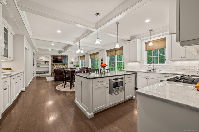35 Bridgehampton Xing, Farmington, CT 06085 - kitchen with open floor plan, dark wood-style flooring, coffered ceiling, white cabinets, and backsplash