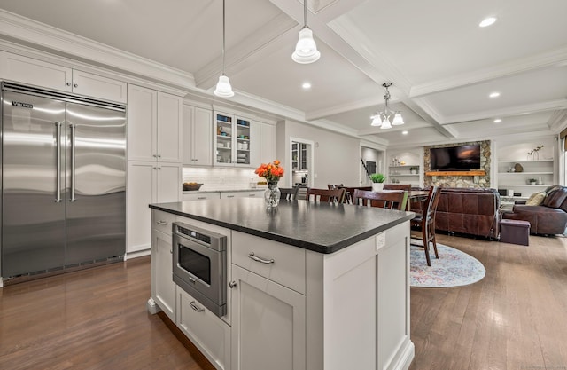 35 Bridgehampton Xing, Farmington, CT 06085 - kitchen with built in appliances, open floor plan, dark wood-type flooring, hanging light fixtures, and glass insert cabinets