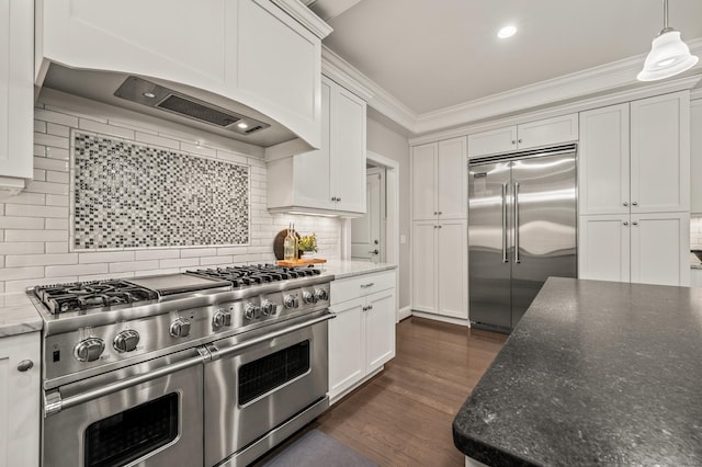 35 Bridgehampton Xing, Farmington, CT 06085 - kitchen featuring premium appliances, decorative backsplash, white cabinets, crown molding, and dark wood-style flooring
