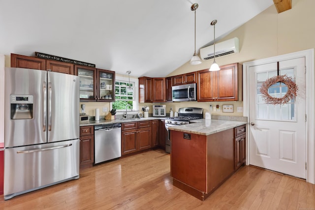 1117 N Grand St, Suffield, CT 06093 - kitchen with stainless steel appliances, an AC wall unit, a peninsula, light wood-style flooring, and vaulted ceiling