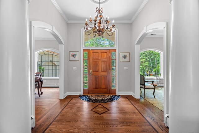 45 Shaker Ct, Guilford, CT 06437 - foyer entrance with arched walkways, wood finished floors, baseboard heating, a baseboard heating unit, and a chandelier