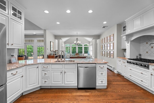 45 Shaker Ct, Guilford, CT 06437 - kitchen with appliances with stainless steel finishes, decorative columns, recessed lighting, dark wood finished floors, and a chandelier