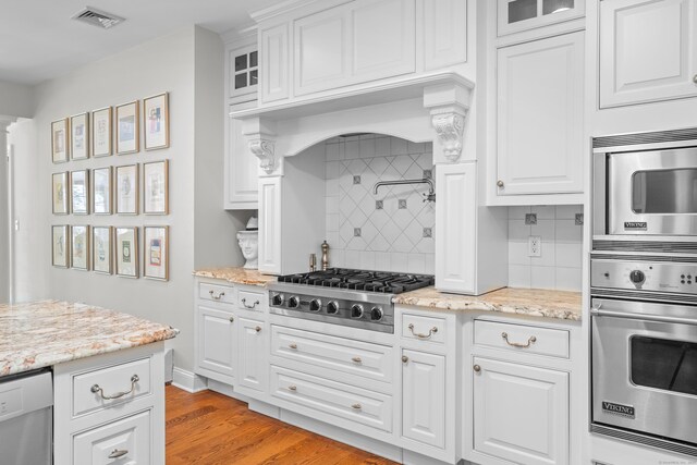 45 Shaker Ct, Guilford, CT 06437 - kitchen featuring stainless steel appliances, backsplash, white cabinets, and glass insert cabinets