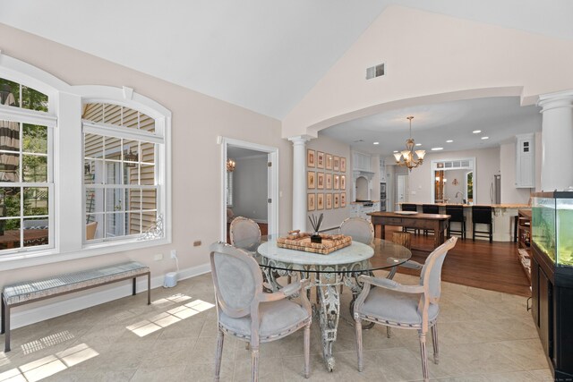 45 Shaker Ct, Guilford, CT 06437 - dining room featuring decorative columns, a chandelier, light tile patterned floors, recessed lighting, and high vaulted ceiling