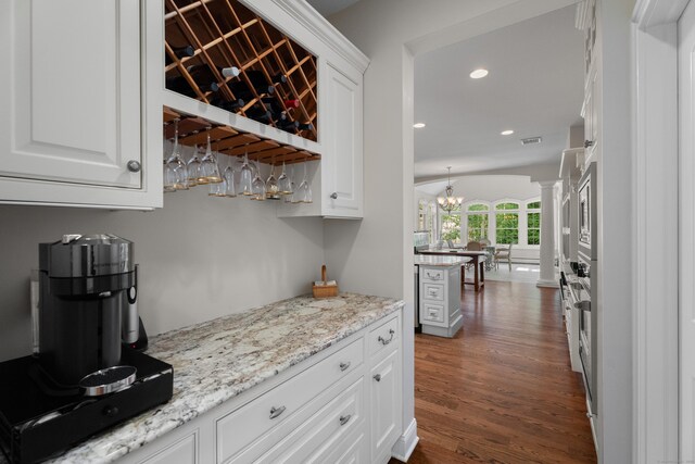45 Shaker Ct, Guilford, CT 06437 - indoor dry bar with dark wood-style flooring, decorative columns, recessed lighting, and a chandelier