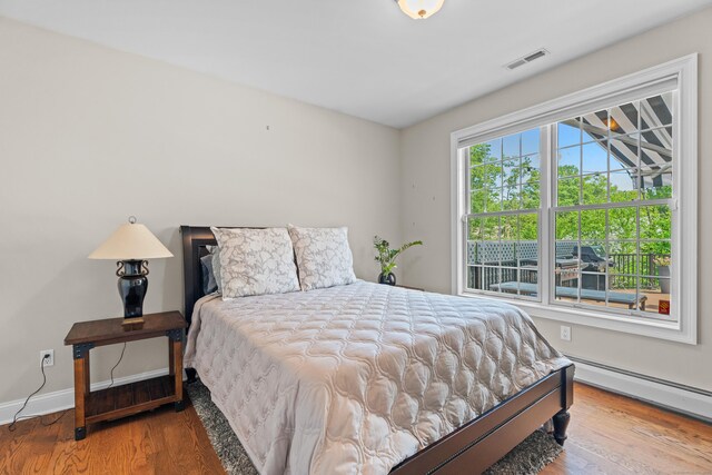 45 Shaker Ct, Guilford, CT 06437 - bedroom featuring wood finished floors and a baseboard heating unit