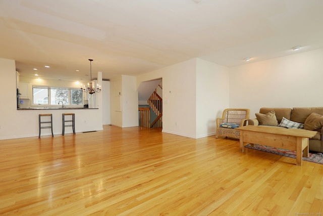 73 Harbour View Pl Unit 73, Stratford, CT 06615 - living area with a chandelier, light wood-style flooring, stairs, and recessed lighting