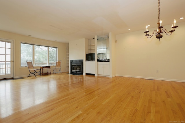 73 Harbour View Pl Unit 73, Stratford, CT 06615 - unfurnished living room featuring a chandelier, light wood-style flooring, and recessed lighting